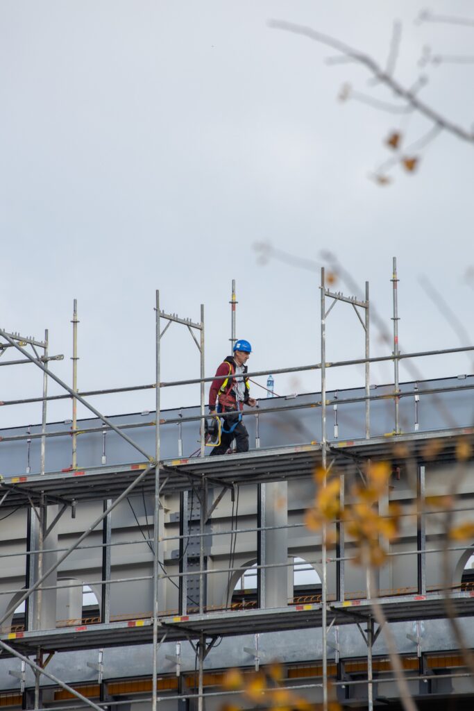 Construction worker walking along scaffolding