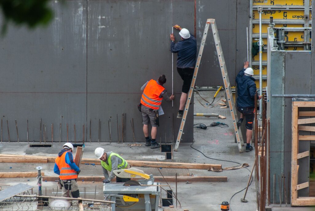 Site shot of building crew working on building exterior